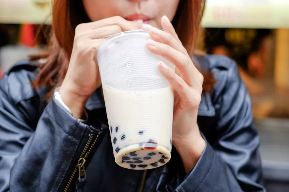 Close-up of woman drinking boba bubble tea through straw